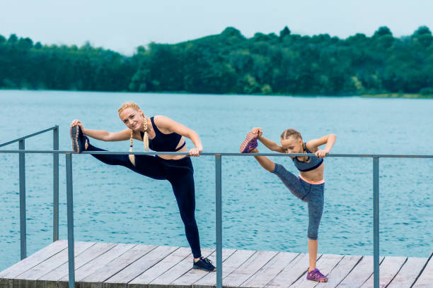 istock Sportive happy mother is doing workout with little daughter 1248568362