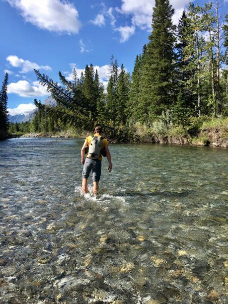istock Young man walks against flowing water in the sun 1248568536