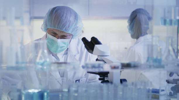 istock Working with biohazardous substance. Woman and man during research 1248569363