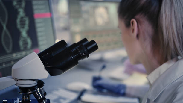 istock Female microbiologist studying coronavirus and its mutations. Futuristic lab 1248569490