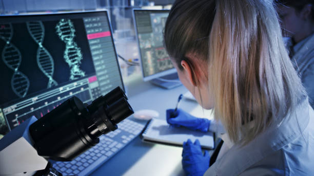 istock Female microbiologist studying coronavirus and its mutations. Futuristic lab 1248569493