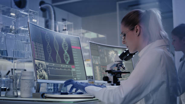 istock Female research team studying DNA mutations. Computer screens with DNA helix in foreground 1248569505