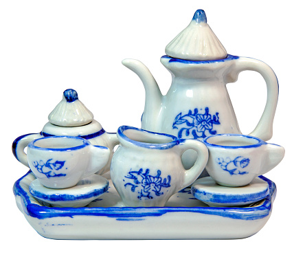 Miniature toy blue and white ceramic tea set with cups, saucers, teapot, sugar bowl and creamer.