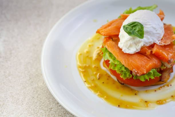 istock Egg benedict with smoked salmon on toast. Delicious breakfast 1248571606
