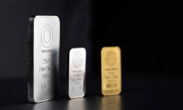 istock Gold and silver bars of different weights on a dark background. 1248571752