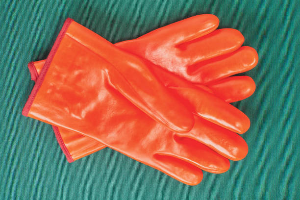 Orange work gloves with chemical protection.