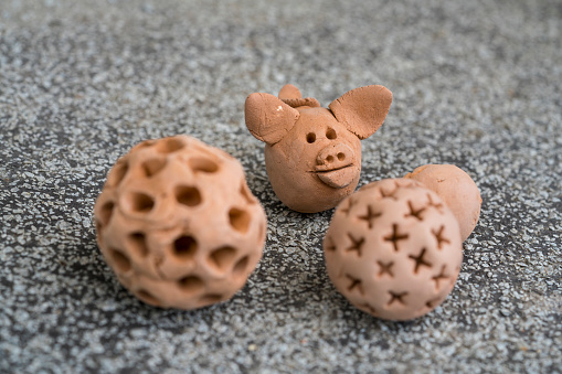 Pig Coronavirus mutations from new covid-19 virus, coming up in next wave of epidemy. it is made of clay against sand on asphalt like stars in space.