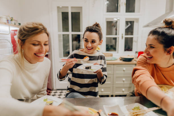 istock Girls having dinner together at home 1248582210