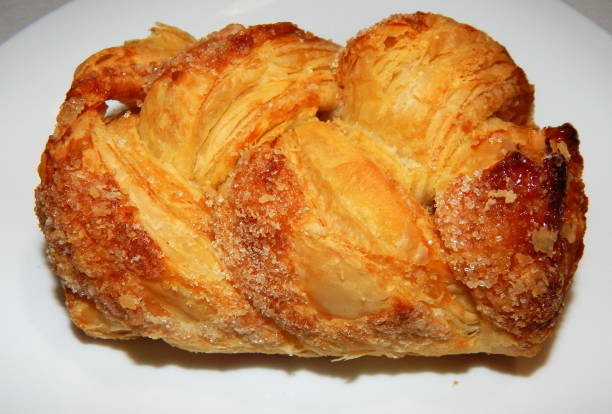 istock Homemade puffs with sugar on a white plate close-up. 1248583400