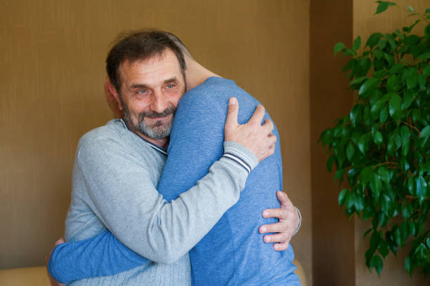 istock senior man hugging his adult son 1248583984