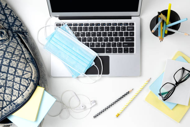 Modern laptop with backpack and stationery on white table Flat lay top view modern laptop with backpack and stationery on white table. Back to school work from home concept new normal concept stock pictures, royalty-free photos & images