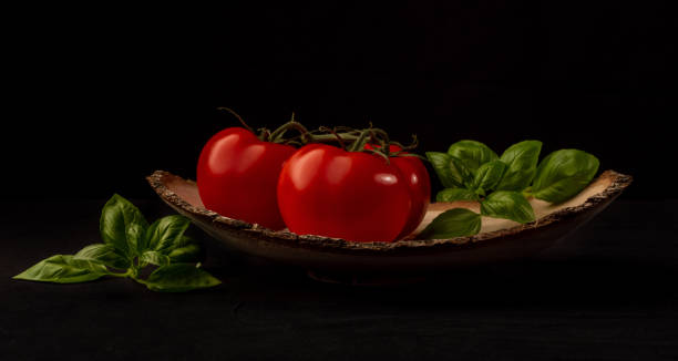 istock Tomatoes and basilicum in wooden bowl 1248585219