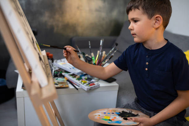 istock A cute young boy doing oil painting 1248585617