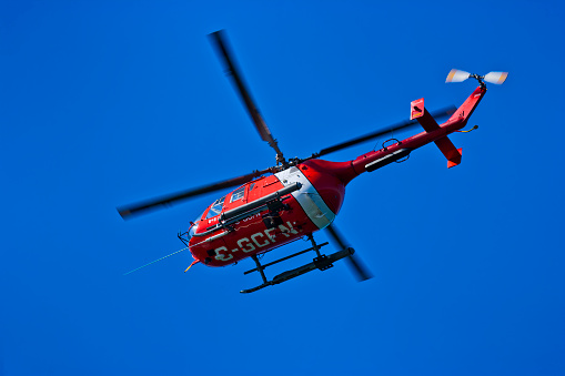 Santander, Cantabria, Spain. Rescue helicopter of the regional government of Cantabria, which patrols the beaches of this region, and in which part of the rescue crew is seen.