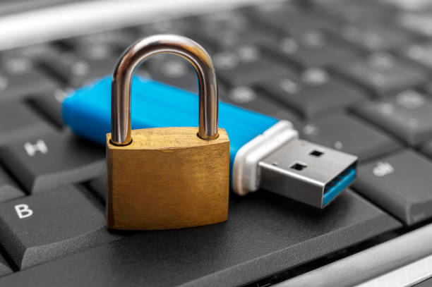 Flash drive with padlock on the laptop keyboard. Flash drive with padlock on the laptop keyboard. usb port photos stock pictures, royalty-free photos & images