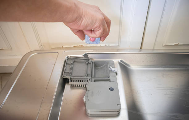 istock Woman putting tablet detergent in the dishwasher 1248589090