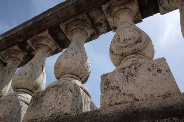 istock Old terrace balusters made of stone or concrete against blue sky. Abstract classical architecture exterior fragment. 1248592737