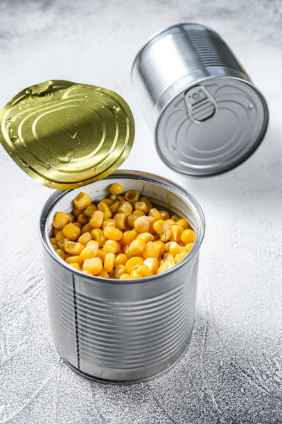 istock Canned corn in a tin can. canned food. White background. Top view 1248593061