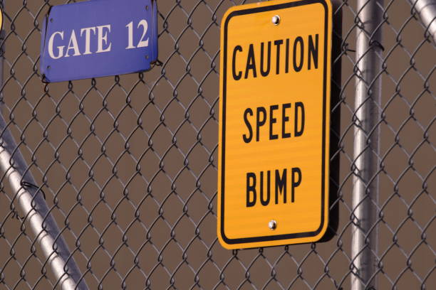 istock Close Up Of Gate With Speed Bump Sign 1248594288