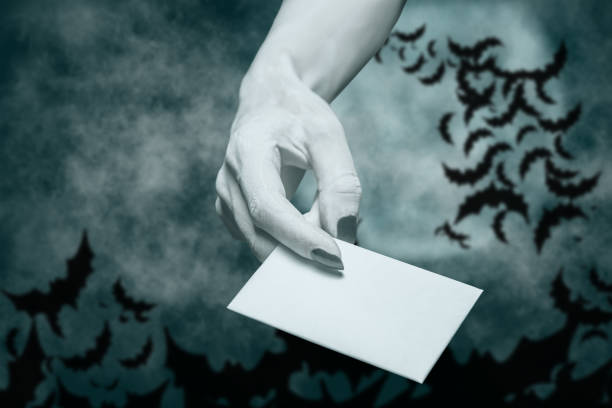 istock Dead hand giving blank card in Halloween night. 1248594833
