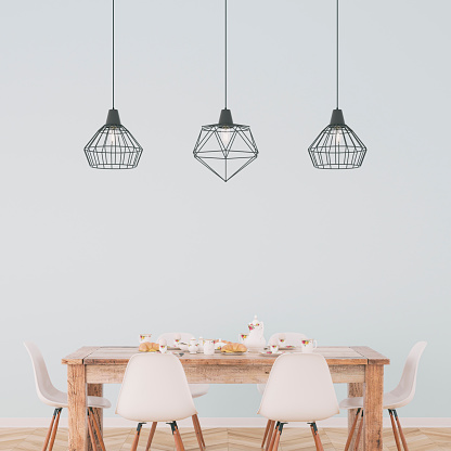 Decorated dining room with full table on hardwood floor in front of light blue plaster wall and pendant lights with copy space in background. Vintage effect applied. 3D rendered image.