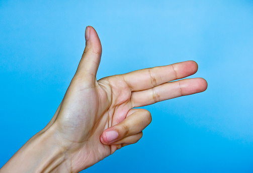 Pointing index finger on isolated blue green color background
