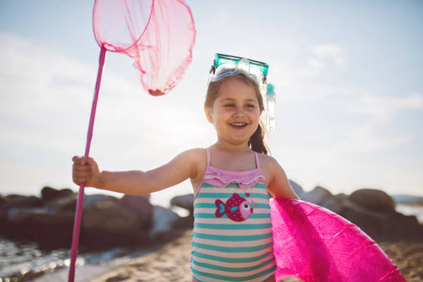 istock Fisher girl having fun on a beach 1248601509