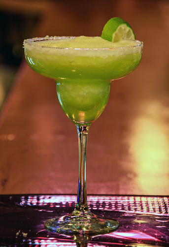Fronzen Marqarita drink with sliced lime and salted rim