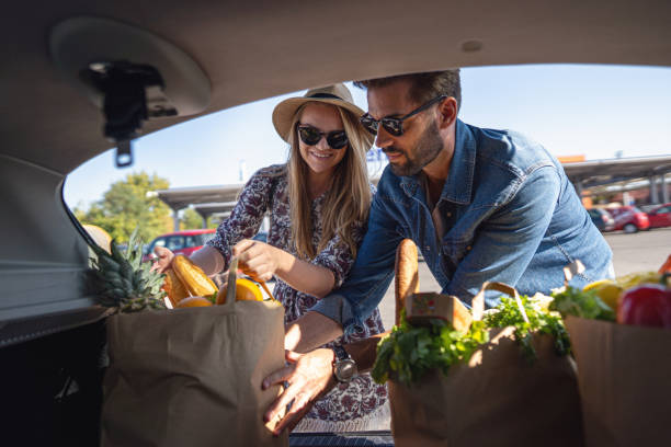 istock Husband and wife leaving supermarket 1248607621