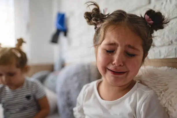 Photo of Sad girl crying in her room