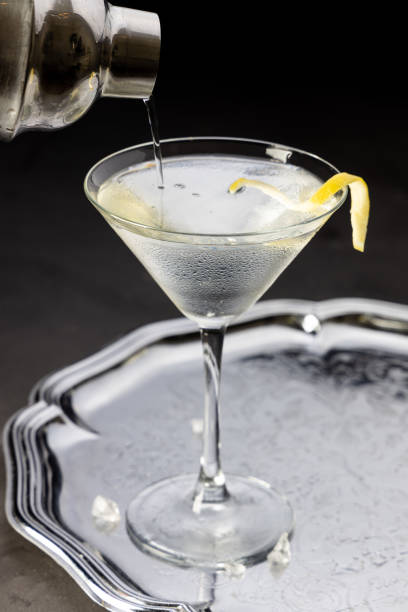 Pouring a martini from a cocktail shaker