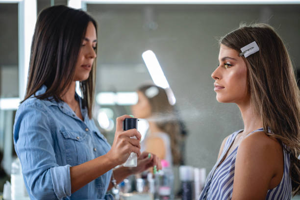 istock Beauty salon professional spraying perfume on her client 1248607879