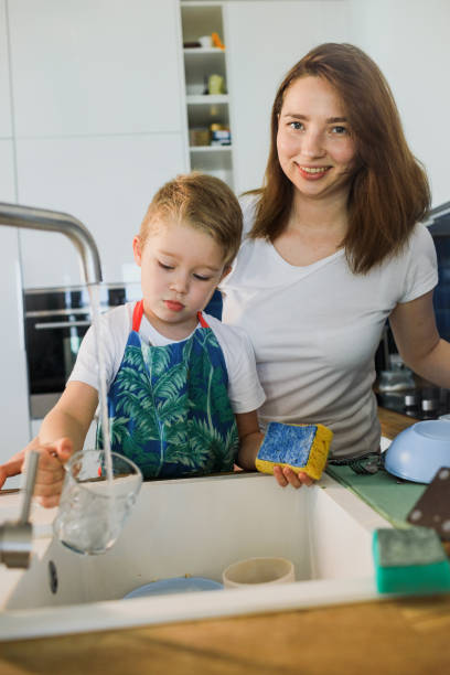 istock mother and son wash dishes together 1248608782