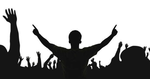 Silhouette of a male athlete raising his gold medal to celebrate his victory in a major sports event. In the background, there is a beautiful sky, creating an atmosphere of glory and splendor due to the athlete's victory