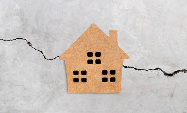 istock Miniature house on cracked cement wall texture background. 1248617984