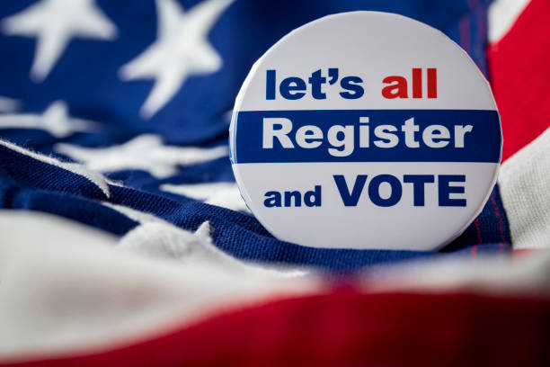 Register the Vote Photograph of register to vote button on American Flag. voter registration photos stock pictures, royalty-free photos & images