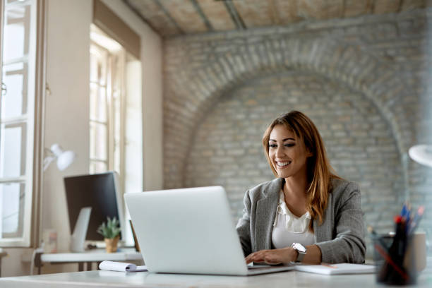 istock Happy female entrepreneur working on a computer in the office. 1248619283
