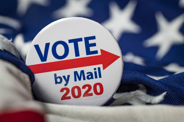 Vote by Mail Photograph of vote by mail election button. absentee ballot photos stock pictures, royalty-free photos & images
