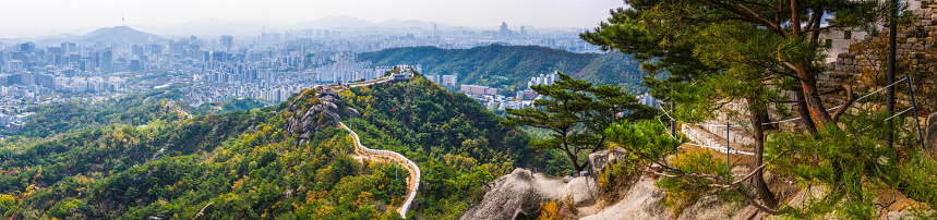 The city walls on top of Inwangsan mountain peak looking out over the crowded cityscape of Seoul, South Korea’s vibrant capital city.