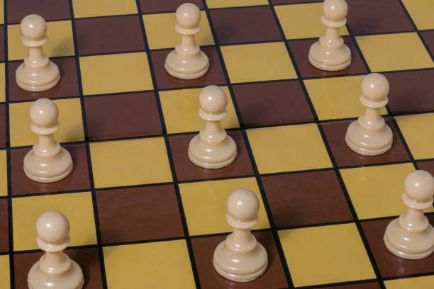 istock Chess pawns located on a board separated by a locker. Social distancing concept. 1248626786