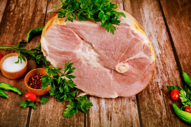istock Whole pork ham with fresh parsley, hot pepper and salt. 1248627472