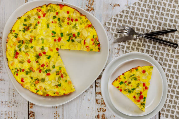 istock Cauliflower and bell pepper breakfast omelette with fork and knife on white background. 1248627473