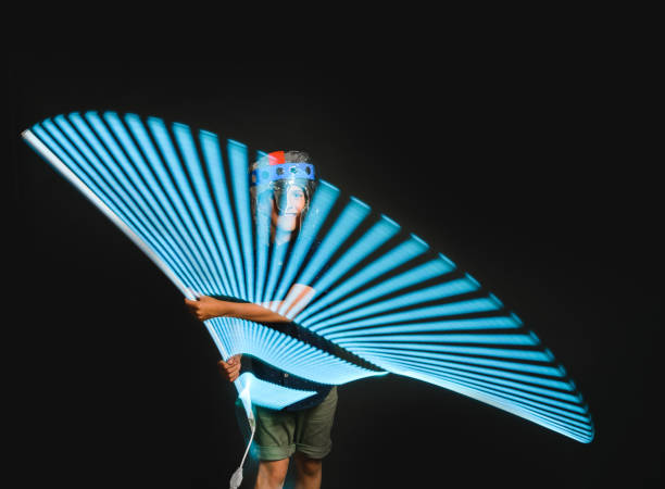 istock A kid with a light saber in his hands play in a superhero battle. 1248630107
