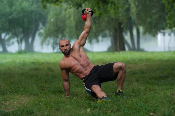 istock Kneeling Muscular Man Exercising With Kettlebells 1248630246