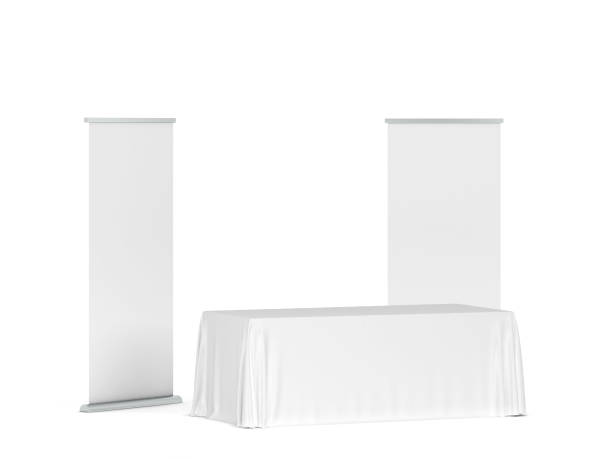istock Blank tradeshow tablecloth with roll-up banners aside 1248630686