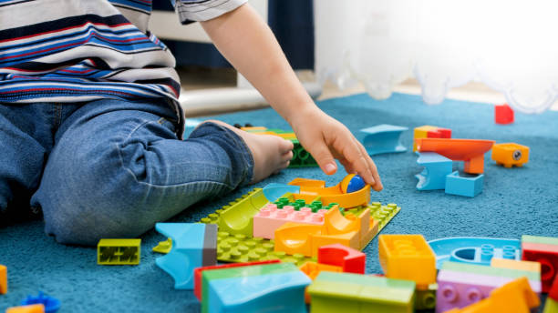 istock Closeup image of little toddler boy assembling track for marble run game 1248631451