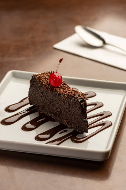 istock chocolate cake slice creamy fudge with cherry on top 1248633702