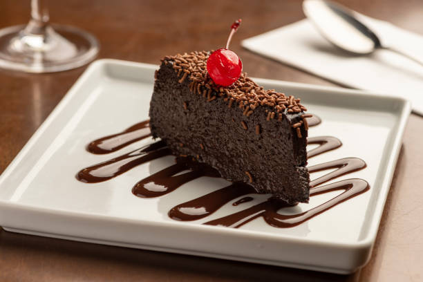 istock chocolate cake slice creamy fudge with cherry on top 1248633744
