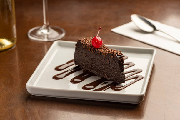 istock chocolate cake slice creamy fudge with cherry on top 1248633745