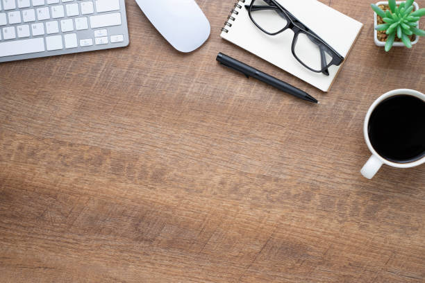istock Wood office desk table with keyboard, notebook and coffee cup with equipment other office supplies. Business and finance concept. Flat lay with blank copy space. 1248639393
